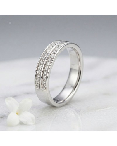 Alliance femme en or avec pierres 5 mm, bague argentée ornée de rangées de diamants scintillants sur fond neutre.