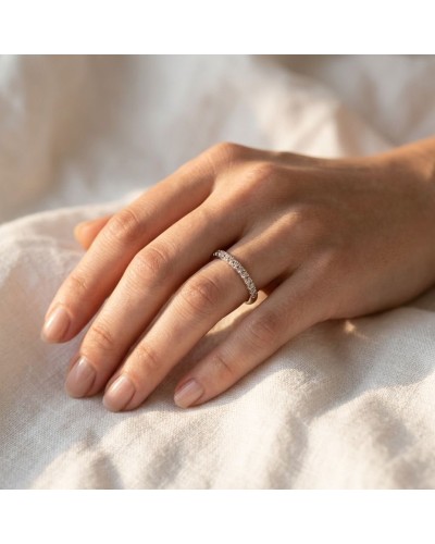Alliance MODESTE demi-empierrée Femme en or: bague délicate ornée de petites pierres sur doigt féminin.