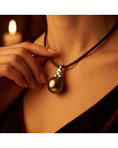 Pendentif perle noire brillante sur cordon noir, avec relief argenté et petites ornamentations près du collier JE M'ATTACHE.