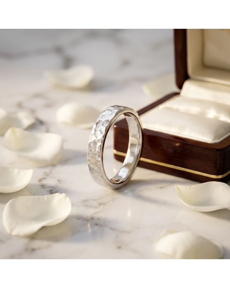 Alliance or martelé pour femme en or argenté, brillamment texturée, près d’un boîtier en bois et cœur blanc.