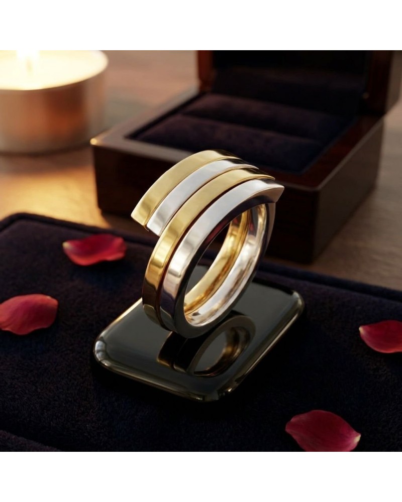 Alliance entrelacée bicolore homme or – bague moderne en or jaune et blanc posée sur un miroir, boîte cadeau en arrière-plan.